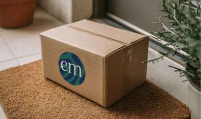 Cardboard shipping box with the Embody logo on a doorstep